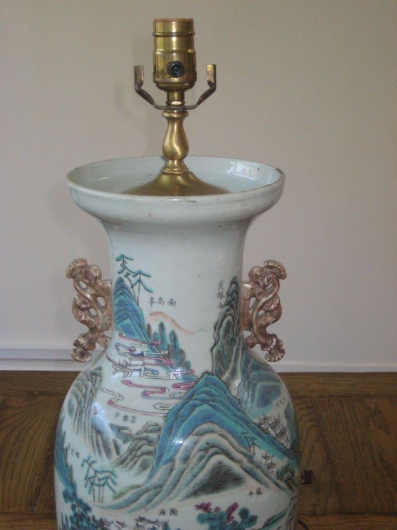 Antique porcelain vase fashioned as a table lamp with mahogany base, depicts pastoral blue mountains. Single standard socket, needs harp.
