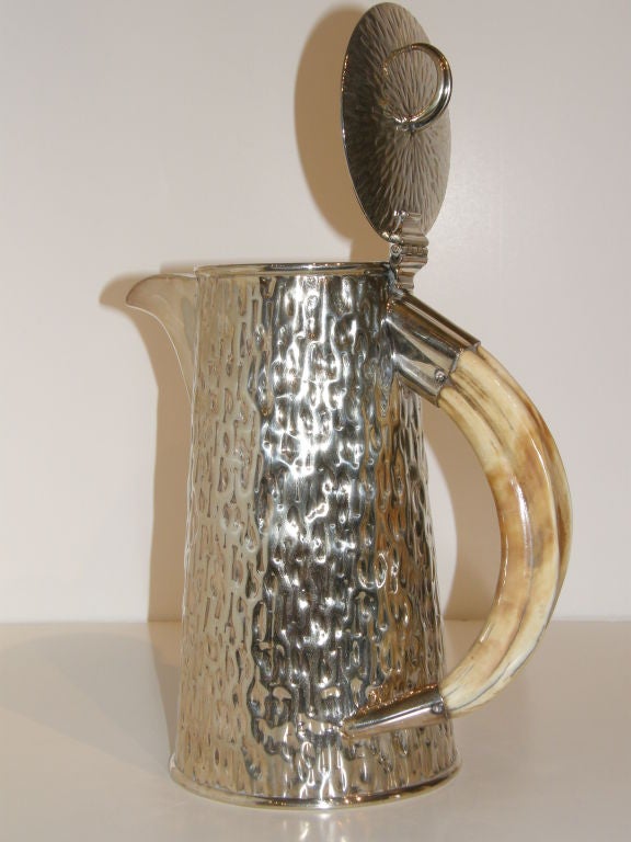 Edwardian hammered silverplated jug with matching pair of beakers, all with horn handles.  By Hukin & Heath, founded in Birmingham in 1855.<br />
<br />
Pitcher: 10 1/4