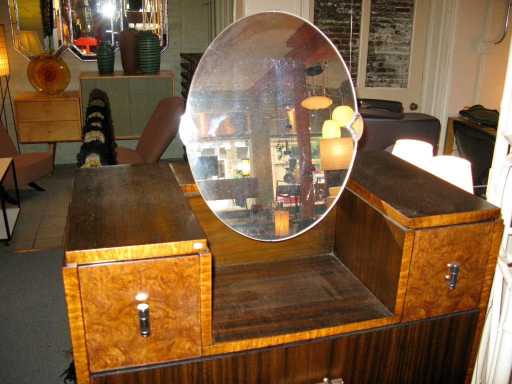 American made 1930's Deco Dresser with an unusual tilting Mirror and mixed exotic veneers.  Chrome hardware.