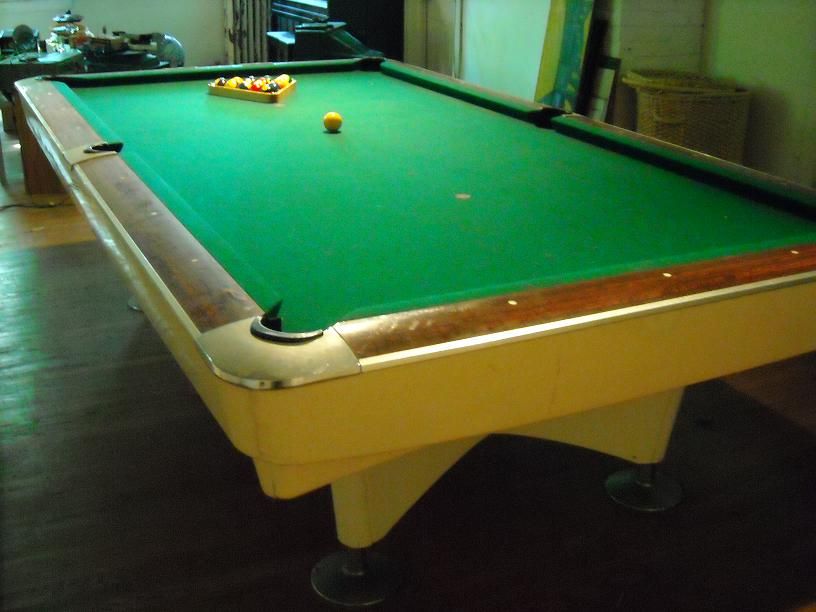 Beautiful 50's Tournament Size Pool Table with newly surfaced felt top.  Rosewood Trim and adjustable aluminum Pod Feet.