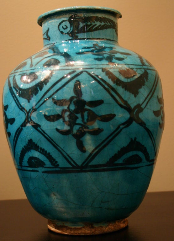 Each vasiform in crackled turquoise glaze; with varying decoration in black; depicting traditional motifs of fish, birds, flowers and scrolls.
