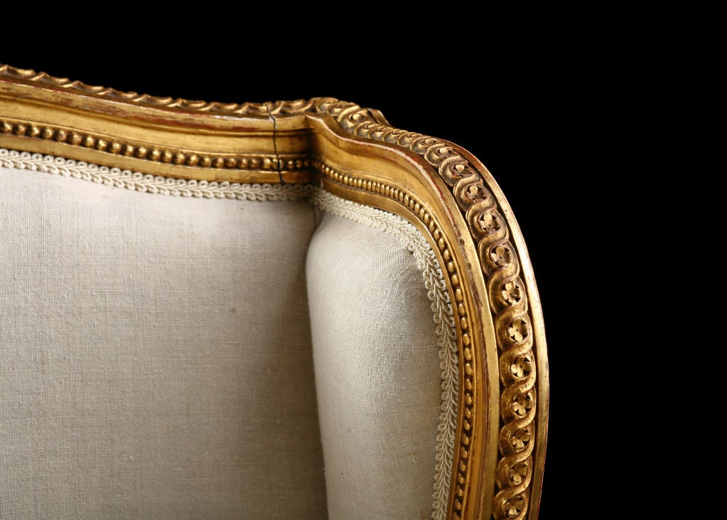 Beautiful French Antique Louis XVI style Giltwood Bergere, newly reupholstered in linen.