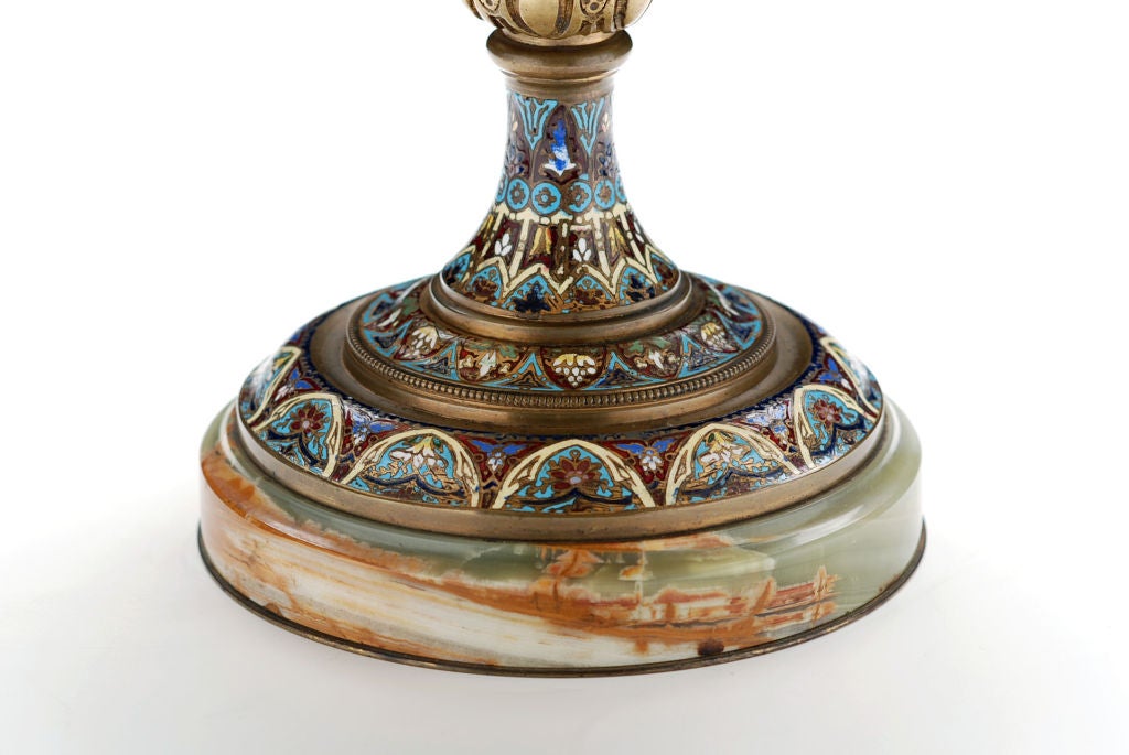 Beautiful onyx tazza with finely chiseled bronze detailing and handles. Fine champleve enamel work on central pedestal and plaque in center plate.  A unique decorative accessory.