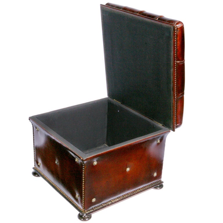 Square tufted Victorian ottoman restored and re-fitted in distressed burgundy leather.  The sides outlined with extra brass tacking and brass rosettes.  A storage chest style - the top opens with a large storage space inside.  (Works great with our