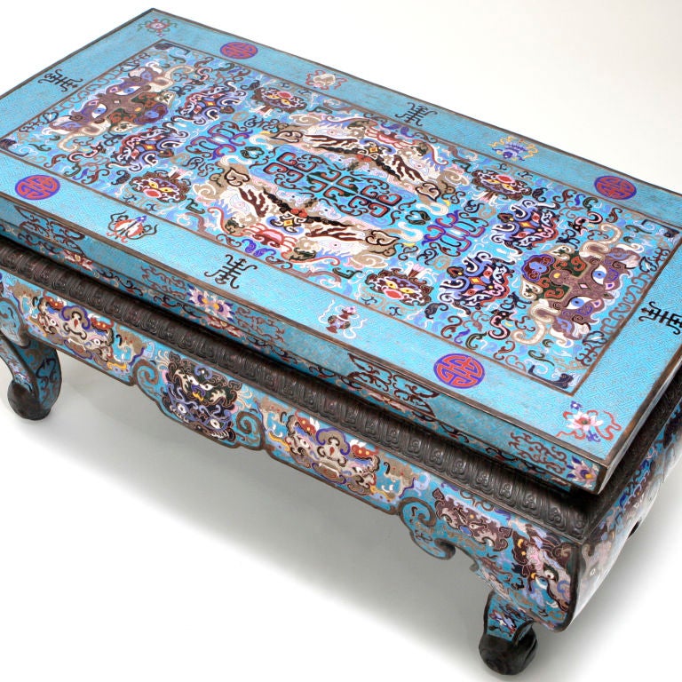 Vintage Chinese export cloisonne coffee table in hard to find blue color tones.  Traditional enameling with multi-colored dragon motif on turquoise ground.  Upper portion of each cabriole leg decorated with stylized dragon face.
