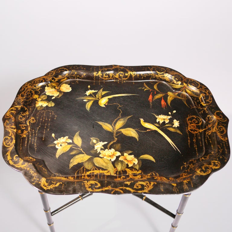 Black lacquer, papier-mache tray table.  Large antique tray  with scalloped edge. As was popular in 19th Century England, it is painted in an Oriental motif with birds, flowers and hanging moss.  The tray stand re-created in a black faux bamboo