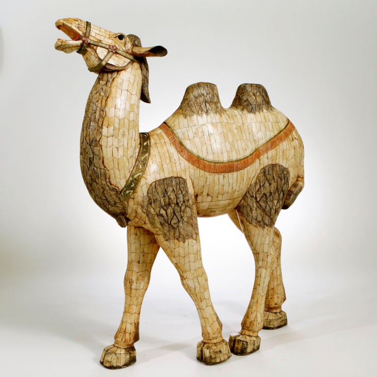 From mainland China, matched pair of large inlaid bone camel figures.  Four-foot high braying animal with bodies that are carved, etched and highlighted with red, black and gold pigment.