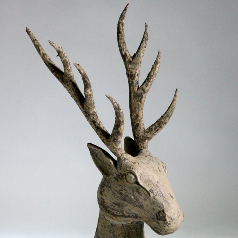 Decorative primitive design carved wood deer.  Large reclining figure has weathered patina.  Originally used as a form or mold for papier mache.  Also available standing.  Two available; price for each.