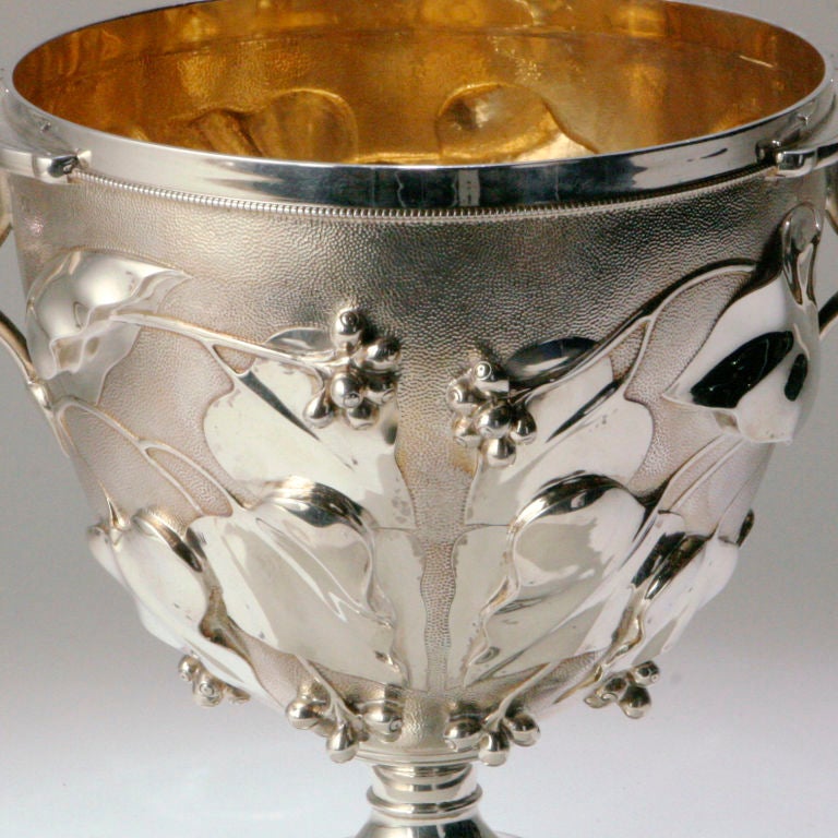 Magnificent rare large sterling silver ceremonial loving cup. This pattern is based on a Roman design discovered in the excavation of Pompeii in the 1600s. The chased three-dimensional vine leaves decorated with sprigs of berries lend a somewhat