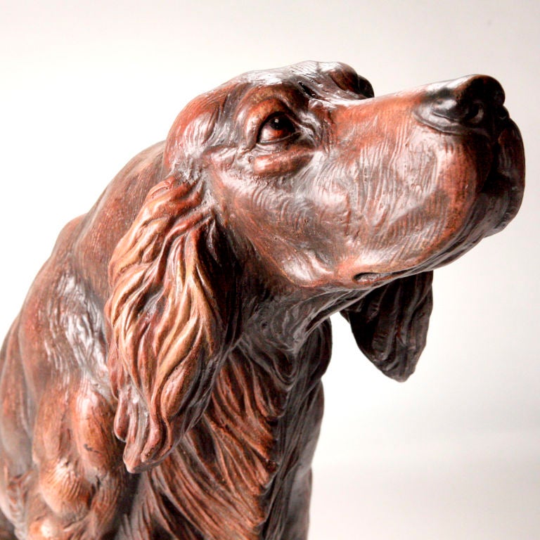 Life-size Victorian terracotta English setter. An unusual model with the seated dog in a very life-like stance. He is expertly detailed with a ruffled chest, long tail and expressive face, as if waiting to be pet!