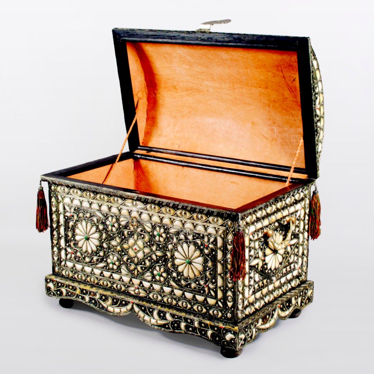 From the Moroccan Berber tribes, an amazing extra-large hardwood trunk.  Handcrafted with fine silver tone metal that is inlaid with camel bone in a geometric flower pattern and studded with amazonite and coral.  The detailed domed top has leather