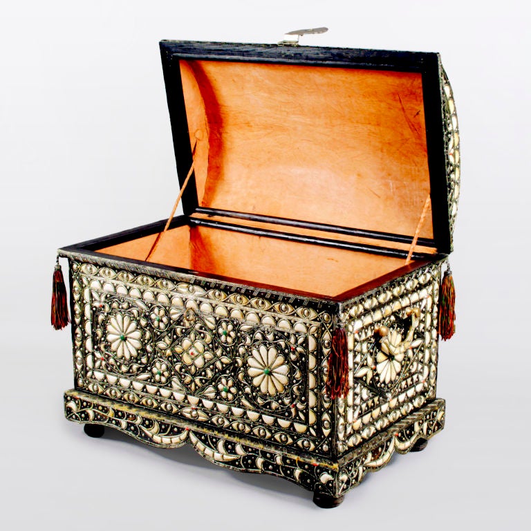 From the Moroccan Berber tribes, an amazing extra-large hardwood trunk.  Handcrafted with fine silver tone metal that is inlaid with camel bone in a geometric flower pattern and studded with amazonite and coral.  The detailed domed top has leather