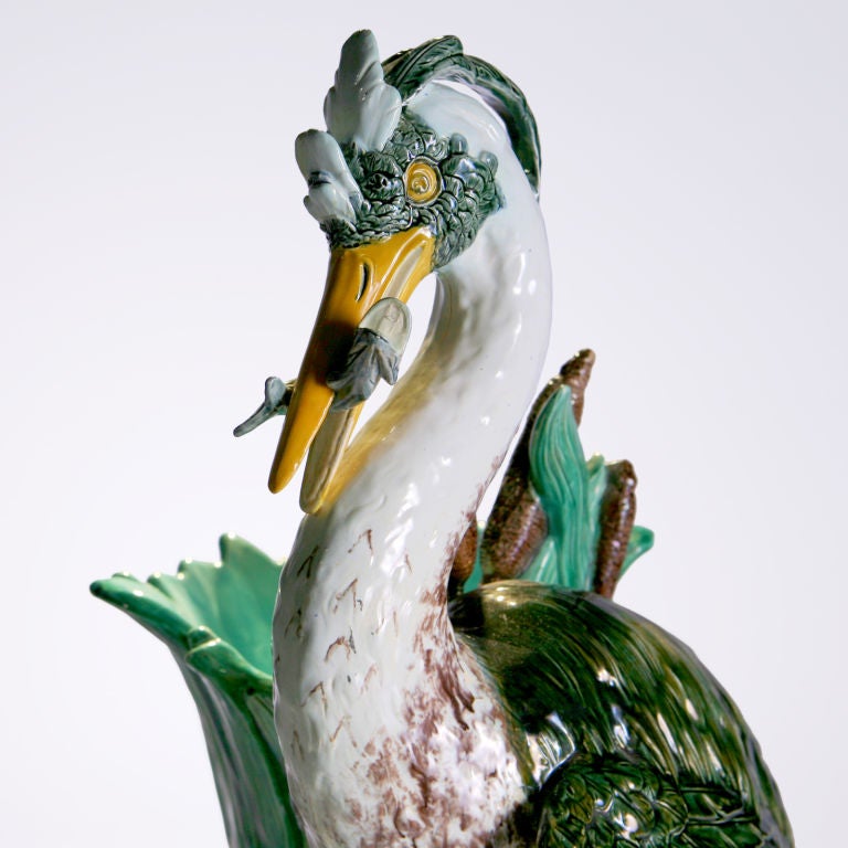 Victorian English Majolica - by Joseph Holdcroft.  A large stick stand or flower holder expertly modeled as a standing heron with a flopping fish in his mouth as he stands perched on one leg.  Detailed with tall grasses with cattail vase and large