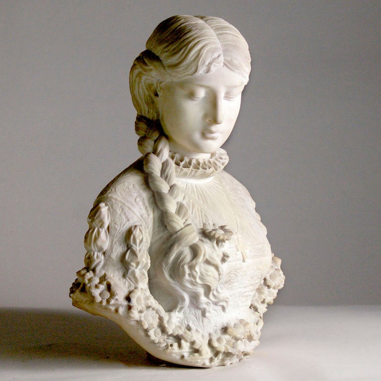 A beautiful white marble bust of a young woman modeled by the 19th century Italian sculptor A. Cipriani. Exceptional detail in all aspects of the design including the braided hair, the Baroque patterned gown, the ruffled collar, the simple cross and