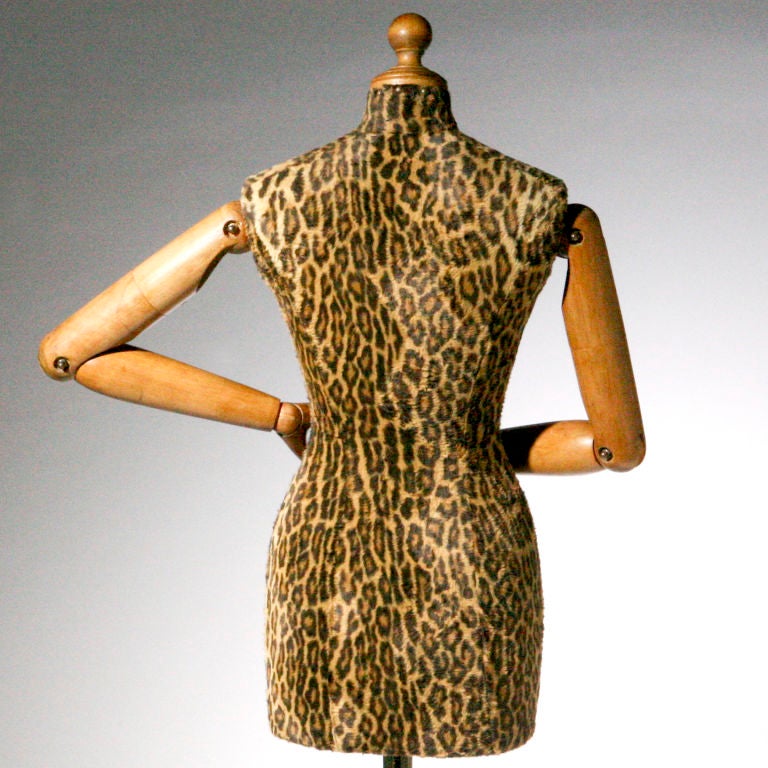 Striking vintage European mannequin with leopard fabric covered body. The smooth wood shoulders, elbows, wrist and fingers are  articulated and rotate on ball joints to be moved into many positions.