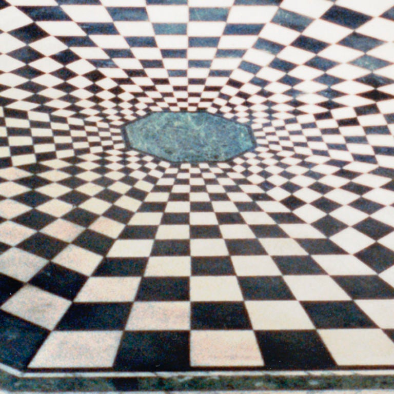 From an 18th century design, vintage octagonal-shaped marble table top in a bold checkerboard pattern. Radiating out from a green marble center are graduating sizes of cut black and white marble forming an ever-expanding checkerboard pattern. The