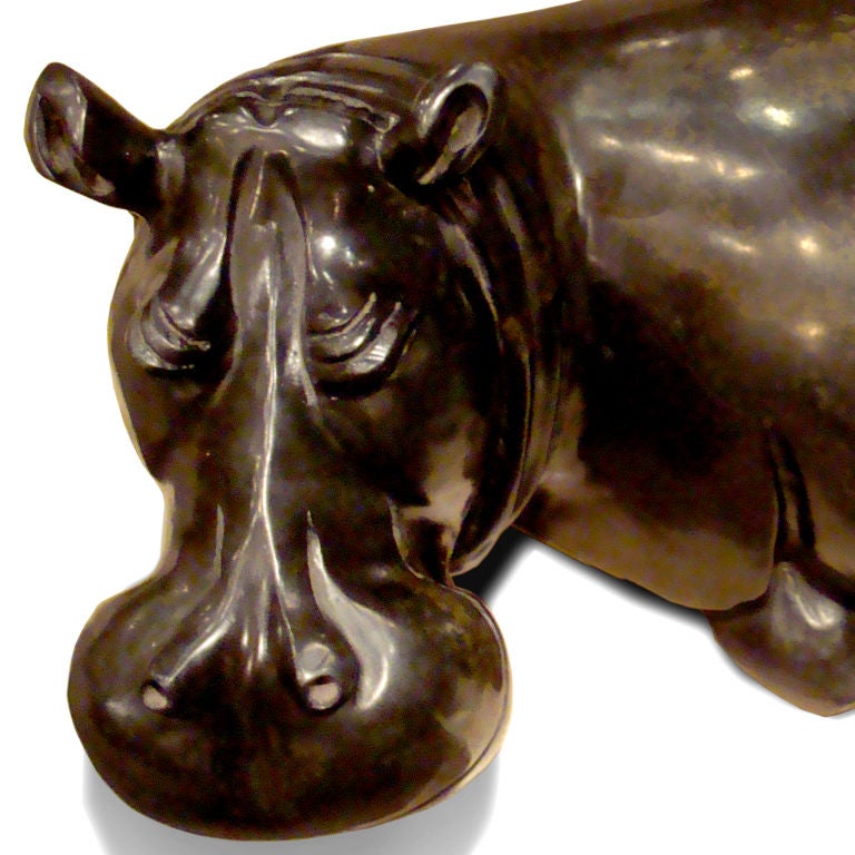 Carved African hippo sculpture of highly polished black springstone.  This drowsy hippopotamus has a large head, closed eyes and unusual soft brown variegation across the back.  Signed by artist: Edwin Chandiringo.  Mined by hand on communal lands