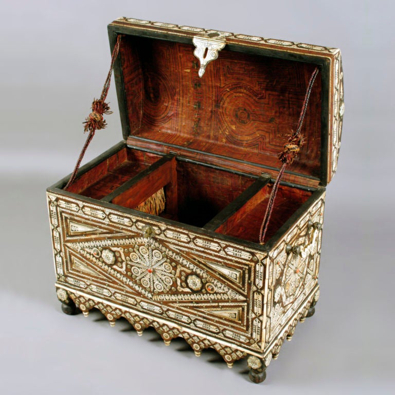 Large Berber Tribe hardwood trunk heavily inlaid with camel bone.  Intricately detailed with fine silver metal and studded with semi-precious coral stones.  Sculpted heavy handles and clasp with inlaid Arabic coin.  Tooled leather inside with