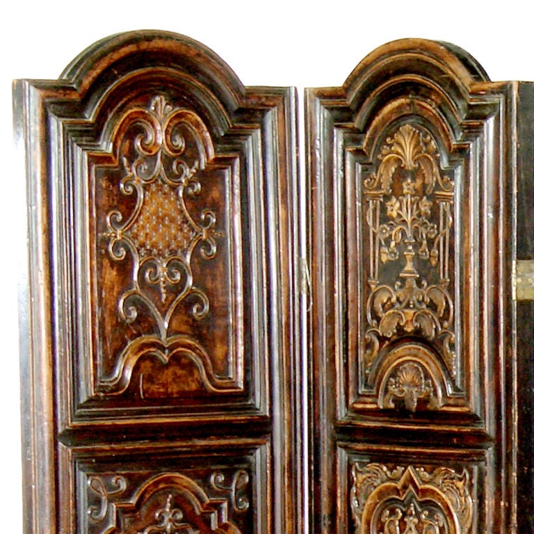 Four-panelled carved hardwood screen with dome-shaped tops, each panel with three ornately carved sections and tiered mouldings.