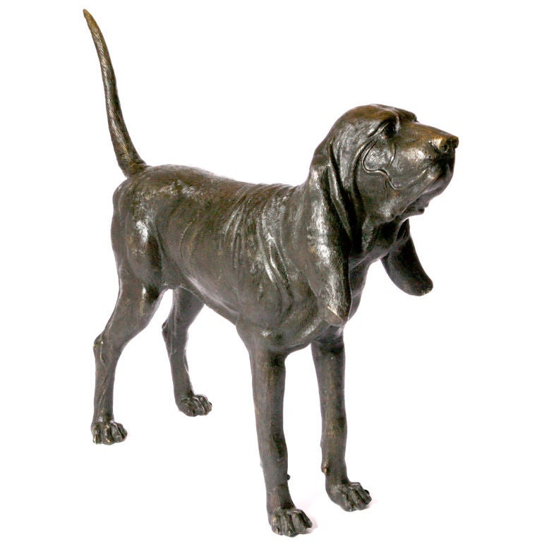 Pair of cast bronze lifesize St. Hubert bloodhound dogs. A matched pair with one seated and one standing. Exquisitely sculpted with expressive life-like features and natural stance. Limited edition.