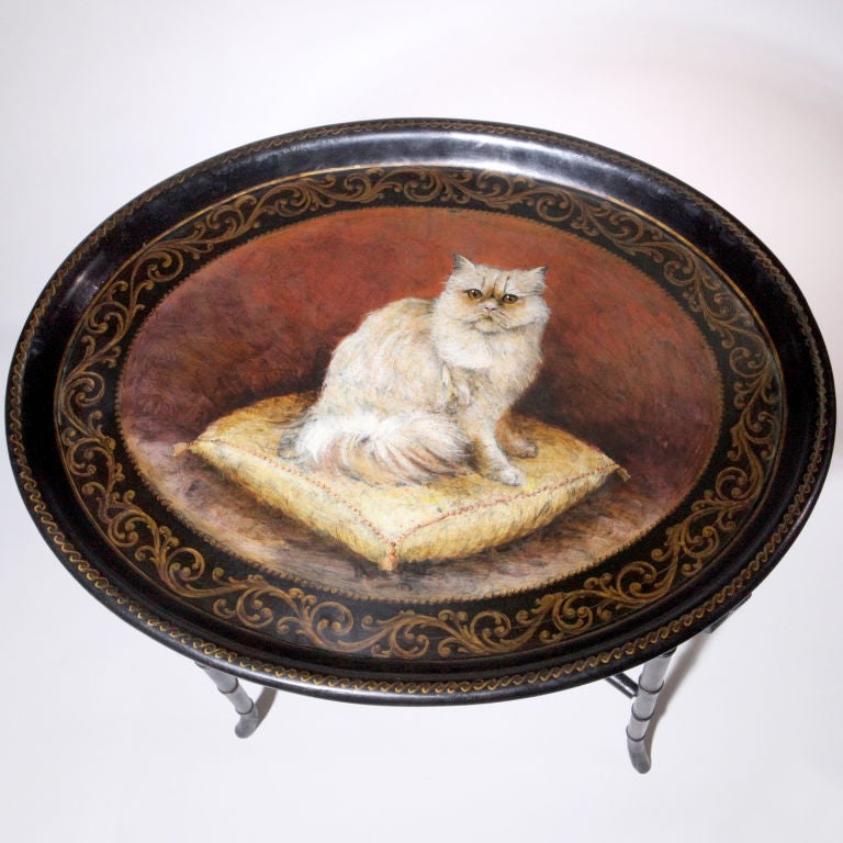 English lacquered papier-mâché tray table. Large oval tray depicting a white Persian cat sitting on a pillow. Beautifully detailed border. Antique tray with contemporary custom-made faux bamboo stand.