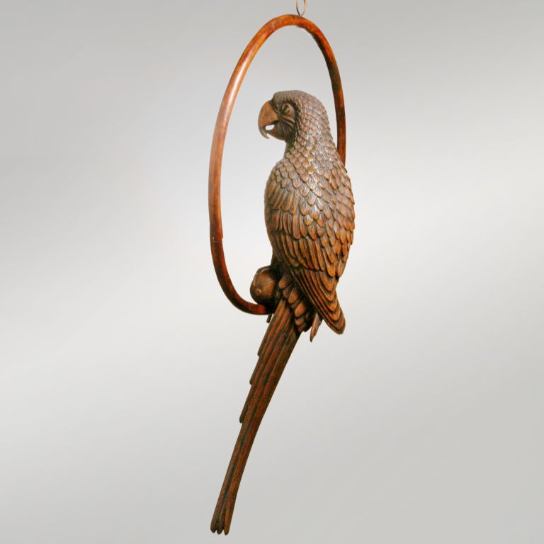 Hanging carved wood parrot perched on circular hoop stand.  The bird by itself is 27 inches high.  Part of a limited edition hand-carved collection.