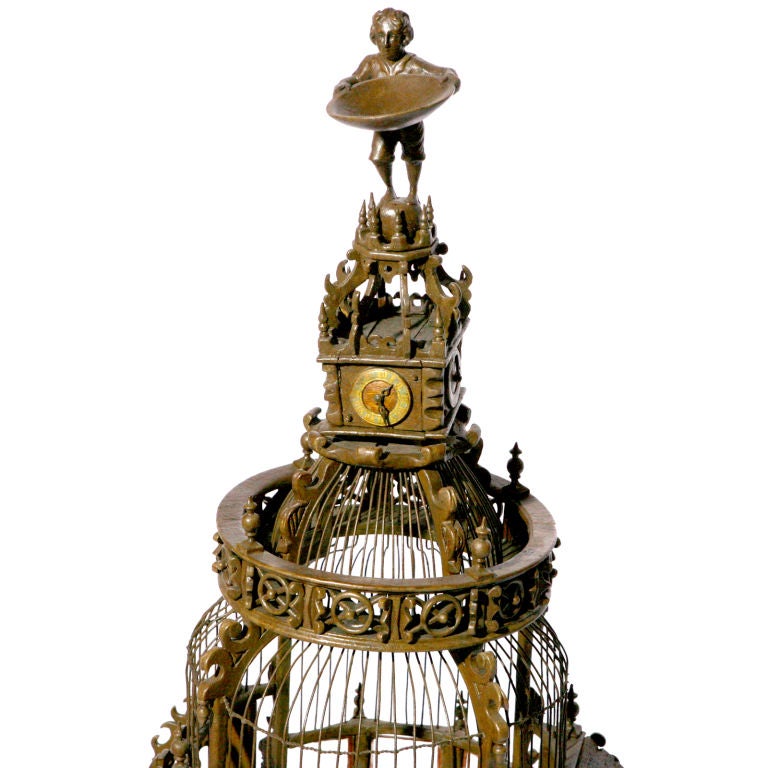 Magnificent seven-foot high custom carved Victorian era bird cage.  Cathedral shape with turrets, balconies and center dome topped with a clock tower and small carved statue.  An architectural wonder with carved swings, feeding cups and sections