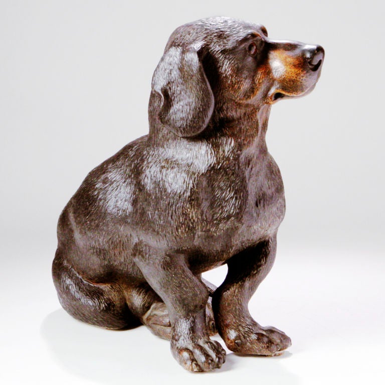 Realistic 19th century terracotta dachshund dog in seated position. Lifesize in deep brown tones beautifully sculpted with distinct facial details and glass eyes.