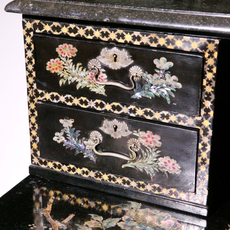Remarkable Victorian Nagasaki technique lacquer work writing desk. Tiered lady's writing desk with four upper drawers topped with black marble. Designed with beautiful inlaid flower pattern using colored mother-of-pearl and abalone shell on white