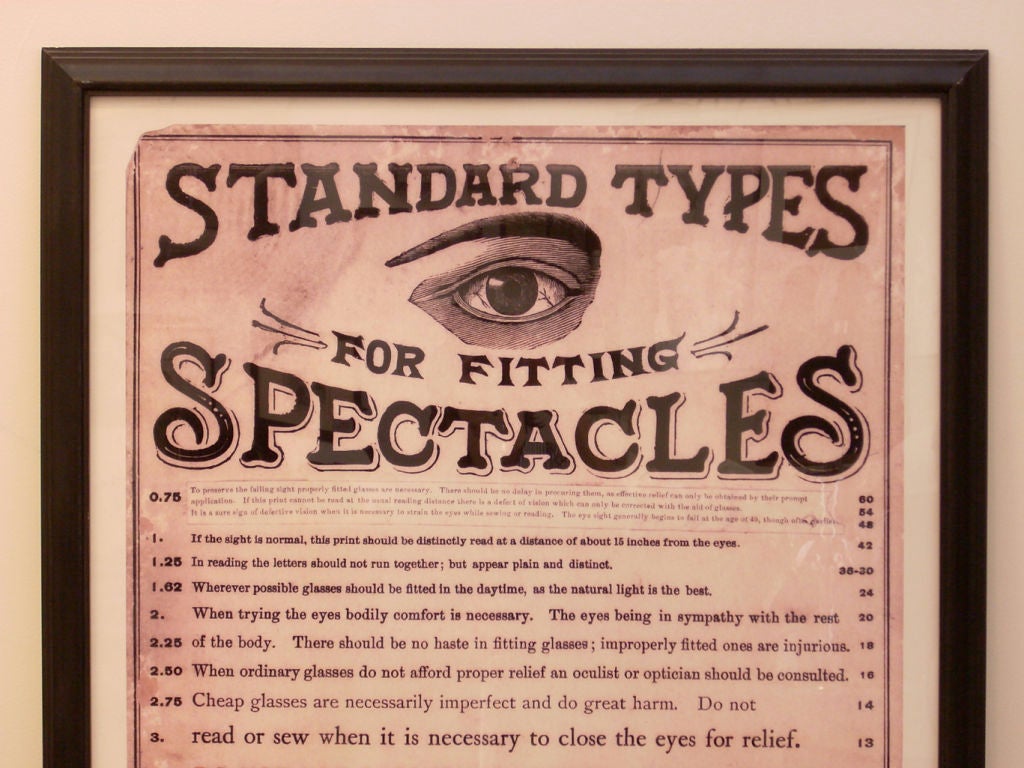 This is an enlarged framed reproduction print of a small optical advertisment.