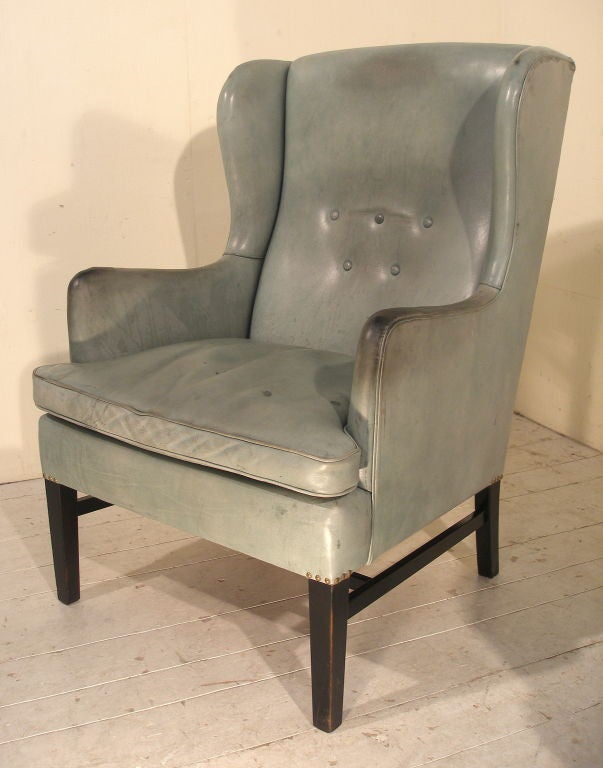 A Pair of Swedish 1960's verdigris hide leather wing arm chairs.