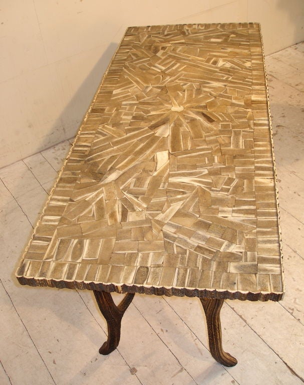 This stunning table has 4 antler horn legs and a top made from hundreds of pieces of antler cut in flat sections. There is even an antler horn edging all the way round.