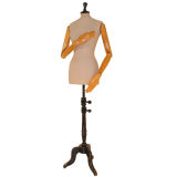 A life size tailor's mannequin on stand with articulated arms