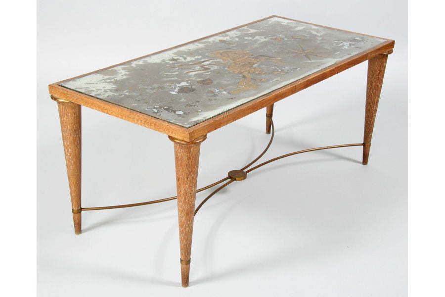 A French, Andre Arbus style limed oak and bronze coffee table with decorated eglomise mirrored top supported by tapered and turned legs circa 1940<br />
<br />
PLEASE VISIT US AT....www.jeffreymarieantiques.com