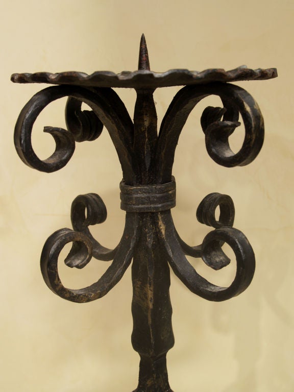 1131- A pair of Italian wrought iron candelabra