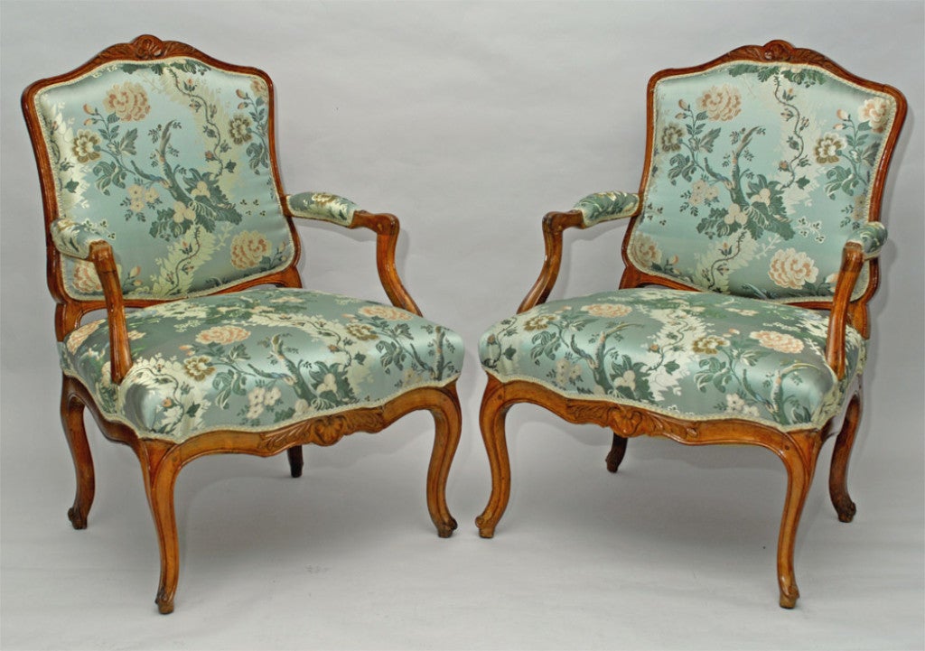 Pair of Italian open armchairs in the French Régence style, c1730, each with a cartouche-shaped padded back, with padded down scrolled arms, the serpentine upholstered seat surrounded by a curved stretcher, raised on cabriole legs, the top and