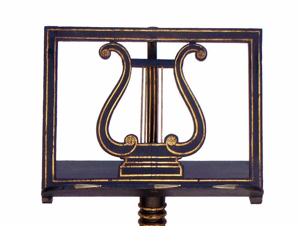 Regency painted and gilt decorated music stand, circa 1810. A Classic design with a lyre in the centre, telescoping adjustable top, turned and banded column ending in a tripod base and small ball feet.
Adjusts to 52” H.