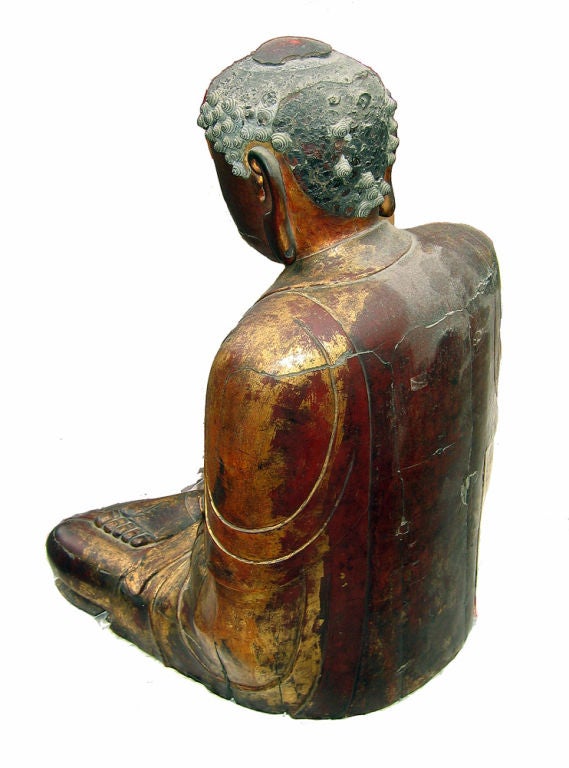 Lacquered Wood Figure of Amitãbha, Yüan/Early Ming Dynasty (late 14th C), with hands resting in his lap in dhyana mundra, a contemplative expression on his face with heavily-lidded eyes, wearing thin monastic robes falling in graceful folds over the