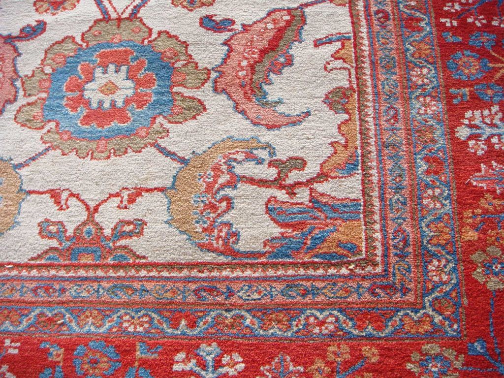 Important Ziegler Sultanabad Rug, Last Quarter 19th Century, stylized flowers in rust, celery green and blue on an ivory ground enclosed within a rust border with cypress trees. Acquired by Lord Iveagh for Elveden Hall, with the original inventory