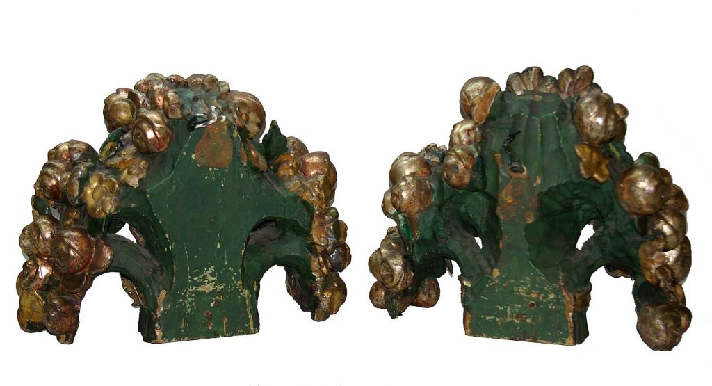 A fine pair of Louis XV circa 1800 gilded and painted floral carvings of gilt ribbon bundled flowers and leaves. The gilding and paint appears to be original, as well as the old iron hanging hooks on their backs.