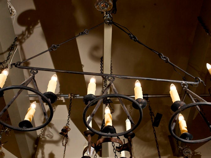 Our exclusive, custom design, the Huron hand-wrought, nine-light chandelier comes with  custom chain and canopy. A clean and timeless design. The diameter of each of the three lights is approximately 14 inches.  Shown in a black finish.  May be