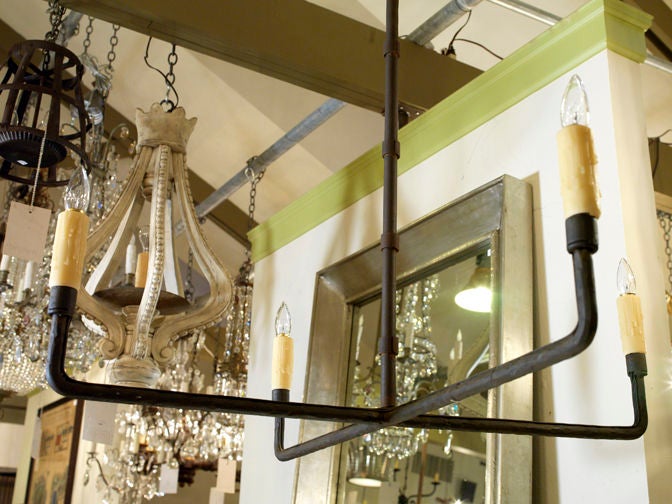 Our exclusive design, the Guernesy is a hand-wrought simple iron sculptural chandelier, blacksmith-made in the USA . Features four candelabra sockets, newly wired with all UL listed parts. Comes with a handmade iron canopy and chain. Shown in photos