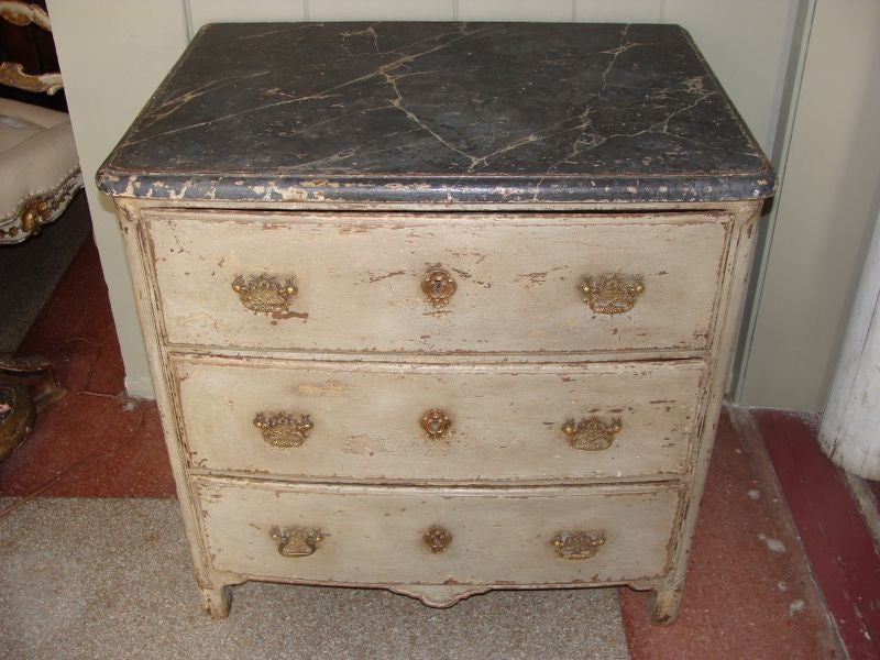 19th century French painted commode with three drawers.  Beautiful French gray aged finish. Top is marbleized in classical dark veined manner.  Provincial simple carving on panels, apron, and front legs, elegant hardware.  Very charming.