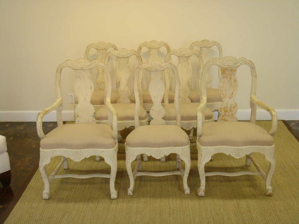 Set of 8 19th century Swedish dining chairs, mixed Gustavian / Rococo style in original white paint. 2 arm chairs & 6 side chairs all with original numbered slip seats.  Armchairs are 1
