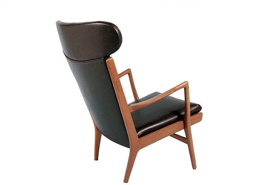Hard to find high back version of the AP easy chair. Solid oak frame, with sculptural arms and new black leather upholstery.<br />
Nice patina to oak. Made by AP Stolen.