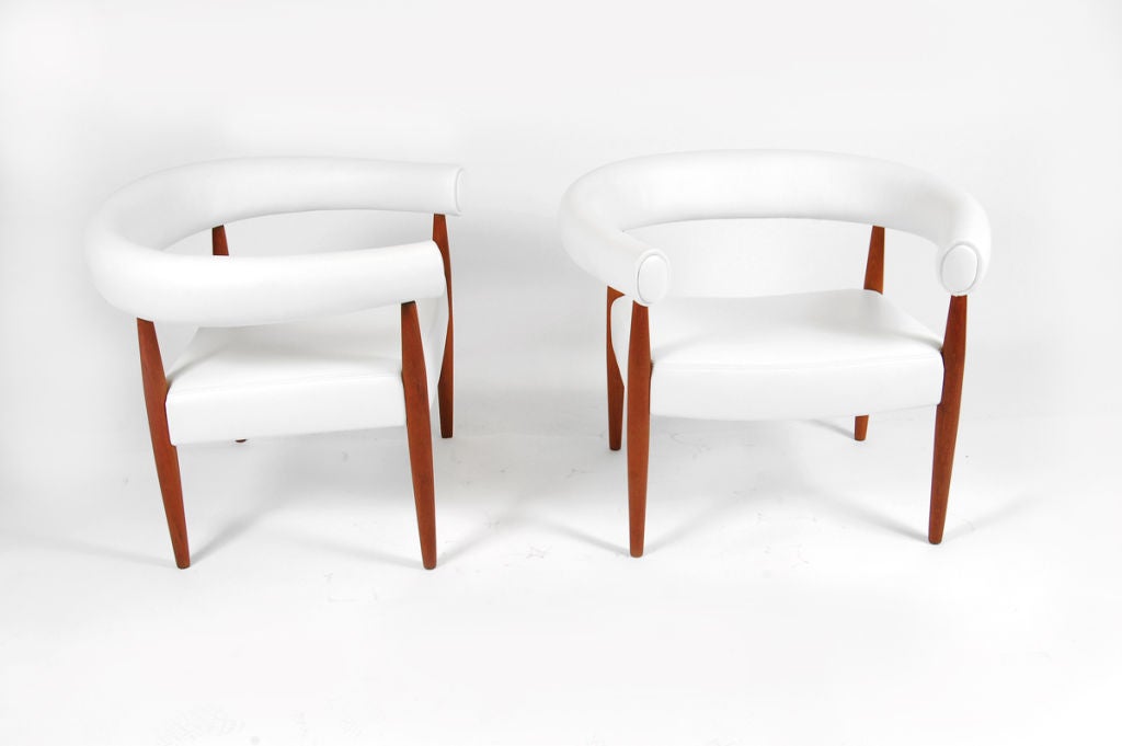 Rare pair of chairs with round back upholstered in new white leather on solid teak legs. Made by Kold Savvaerk.