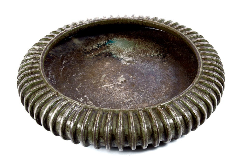 Large shallow bowl with ribbed edge. Green/gray/brown glaze.<br />
Signed on bottom.