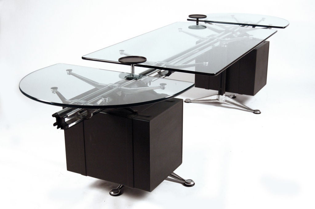 This piece can be used as a table only or as a desk; the two hanging file drawers are suspended from the beam and can easily be removed. Table is comprised of three glass pieces made up of two semi-circles and one rectangle; the glass is 5/8