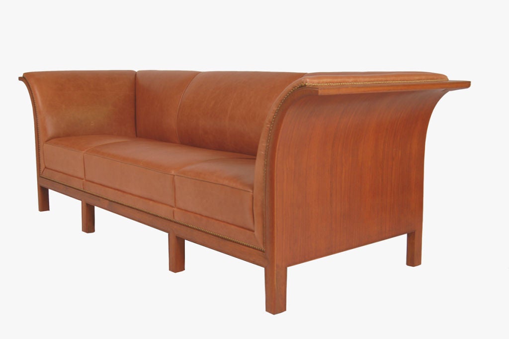 Rare Henningsen sofa with teak frame, new leather upholstery and brass nailhead trim. One of Henningsen's most sought after designs.