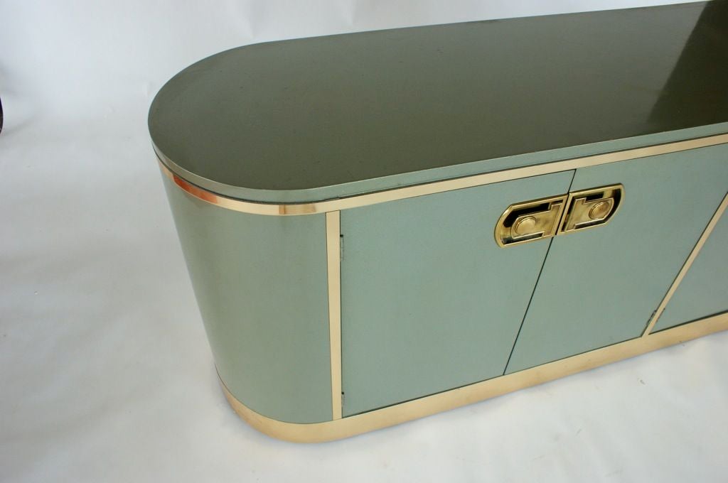Brass trim and  hardware details,4 door 4 drawer and adjustable shelf credenza in beautiful metallic blue lacquer.